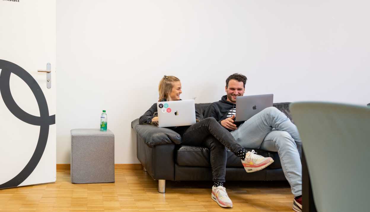 Fabienne and Martin on a Sofa with their laptops